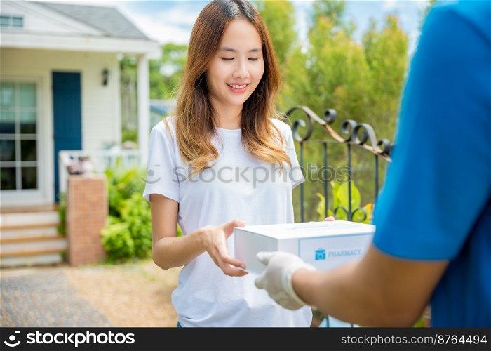 Delivery man give medicine drug to patient female at home, Sick Asian young woman receive medication first aid pharmacy box from hospital delivery service, healthcare medicine online concept