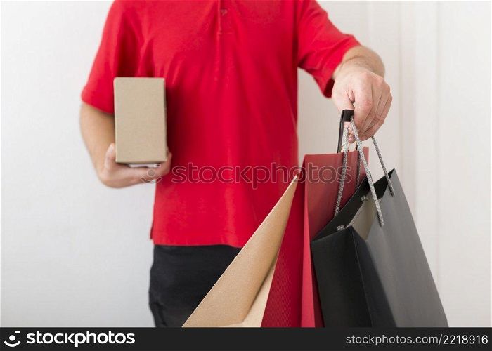 delivery man holding shopping bags