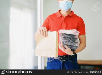 Delivery man wearing protective face mask coronavirus and hand holding craft paper food packaging Service, Postman and express Diverse of paper containers for takeaway food delivery service to home