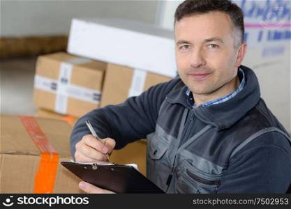 delivery man with parcel near cargo truck shipping service