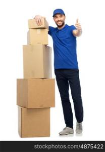 delivery service, mail, people, logistics and shipping concept - happy man with parcel boxes showing thumbs up