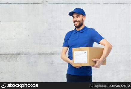 delivery service, mail, people, logistics and shipping concept - happy man with parcel box over gray concrete wall background. happy delivery man with parcel box