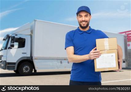 delivery service, mail, people, logistics and shipping concept - happy man with parcel boxes over truck on street background. happy delivery man with parcel boxes