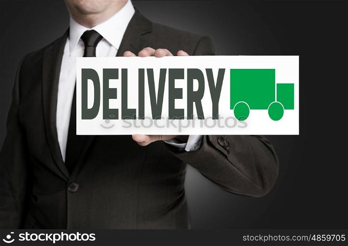 delivery sign is held by businessman. delivery sign is held by businessman.