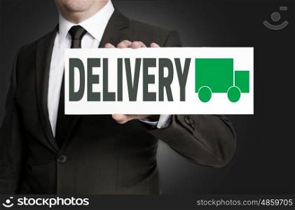 delivery sign is held by businessman. delivery sign is held by businessman.