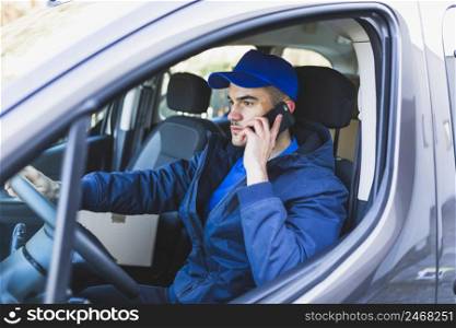 deliveryman having phone call car