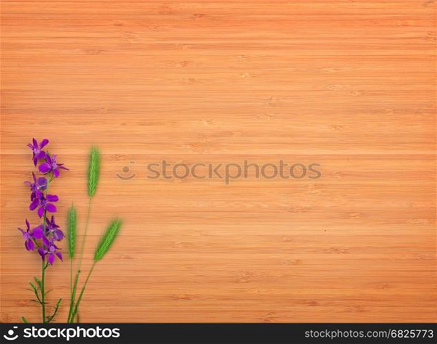 Delphinium flower on a wooden background. Free space for text. The top view.