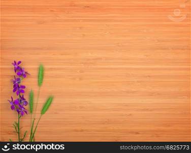 Delphinium flower on a wooden background. Free space for text. The top view.