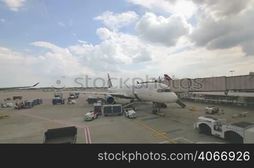 Delta Airlines plane refueling and all airport services preparing flight. Video time lapse preparing the aircraft for next takeoff in the United States of America. Filling the tank of kerosene, putting luggage in the trunk and preparing the flight catering.
