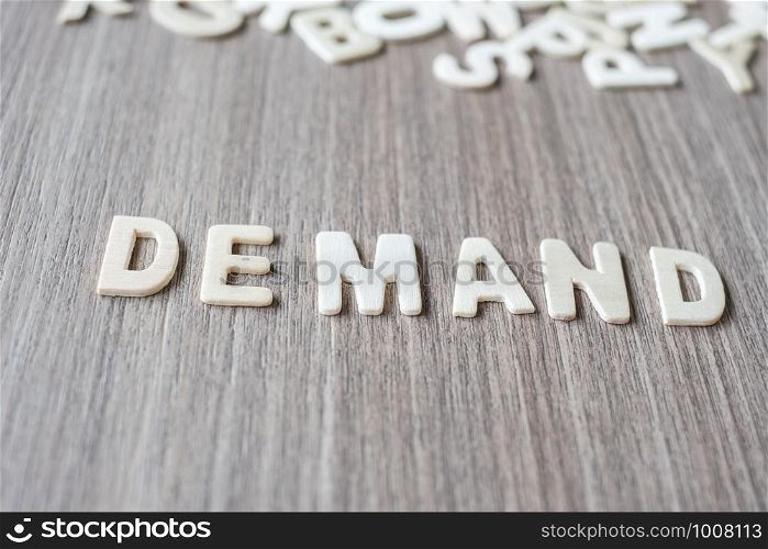 DEMAND word of wooden alphabet letters. Business and Idea concept