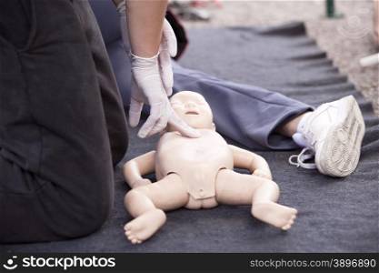 Demonstrating CPR on a infant dummy