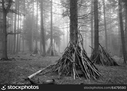 Den building area for children in forest landscape on foggy Autu. UK. Den building area for children in woodland landscape on foggy Autumn morning in black and white