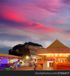 Denia in Alicante sunset with fairground fair at Spain