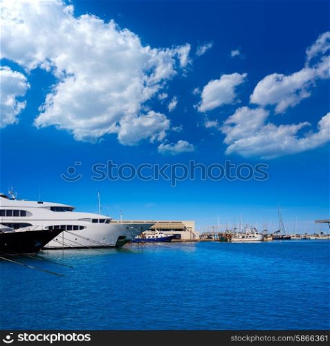 Denia marina port in Alicante Spain with boats in a sunny blue day