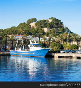 Denia mediterranean port village with castle mountain and blue sea water