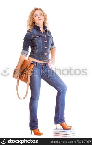 Denim fashion and education. Full length college university student girl with bag books, casual woman in stylish blue jeans pants and jacket high heels. Isolated on white background