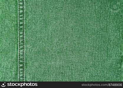 Denim jeans texture background. Texture of green colored cotton fabric with decorative seam. Stiched texture jean background. Fiber and fabric structurel. Wallpaper, banner, backdrop, header