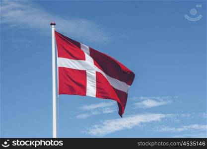 Denmark flag in red and white colors on a pole