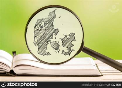 Denmark information with a pencil drawing of a Denmark map in a magnifying glass