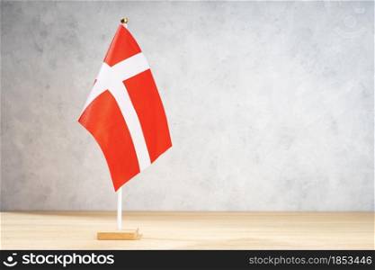 Denmark table flag on white textured wall. Copy space for text, designs or drawings