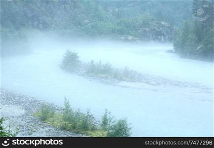Dense fog over a mountain stream (Norway).