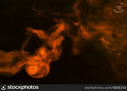 dense fumes abstract orange smoke dark background. High resolution photo. dense fumes abstract orange smoke dark background. High quality photo