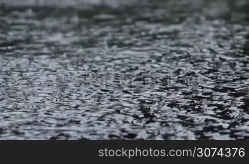 dense rain pours pavement