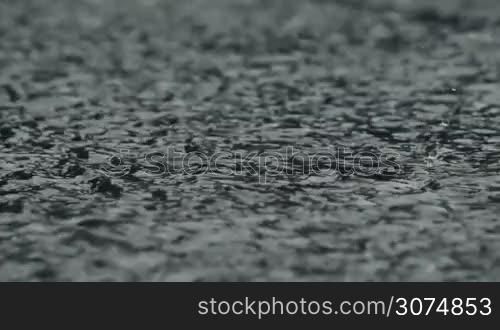 dense rain pours pavement