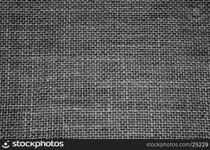 Densely woven material made of string in black color, with clearly visible strands and fine threads.Texture and background. Close,horizontal view.