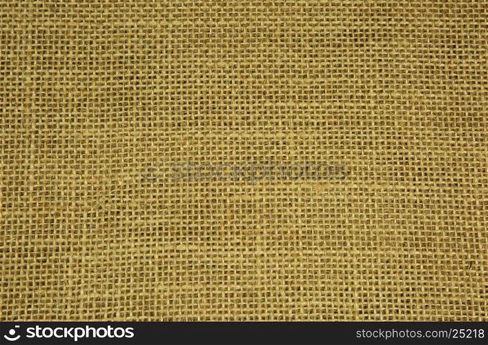 Densely woven material made of string with clearly visible strands and fine threads, in light brazowym.Texture, and background. Close, horizontal view
