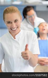 Dental assistant dentist checkup patient woman at professional clinic thumbup