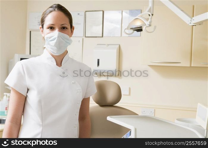 Dental assistant in exam room with mask on