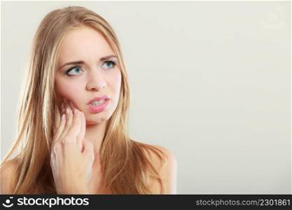 Dental care and toothache. Closeup young woman face worried girl suffering from tooth pain