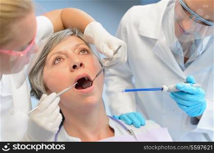 Dental check elderly woman patient professional dentist team open mouth
