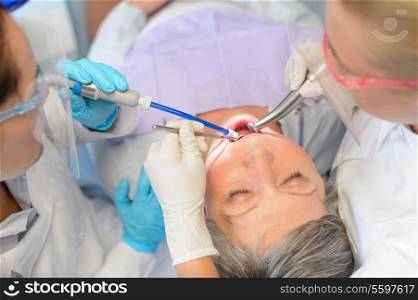 Dental checkup senior patient woman professional dentist team top view