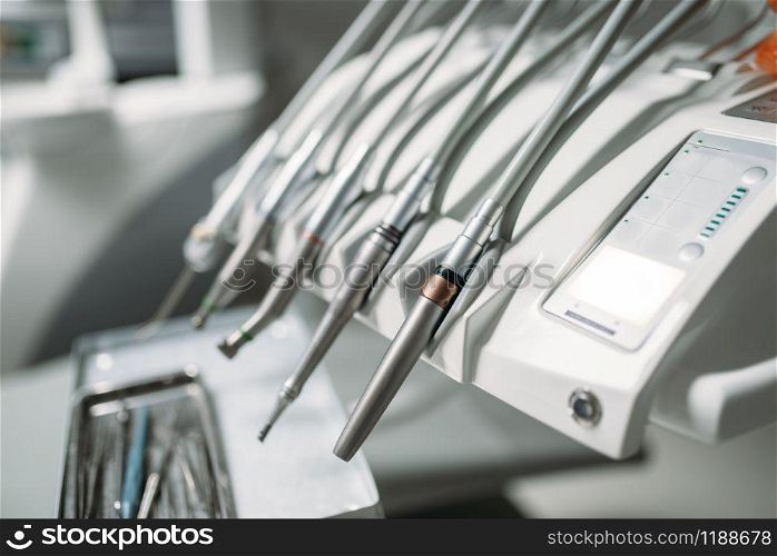 Dental drill closeup, stomatological equipment in dentistry clinic, stomatology cabinet interior, nobody. Dentist tools, orthodontist workplace