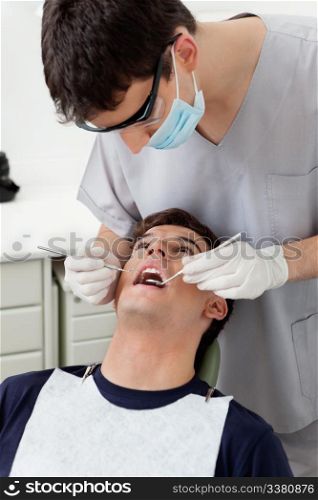 Dental hygienist working on patient&rsquo;s teeth
