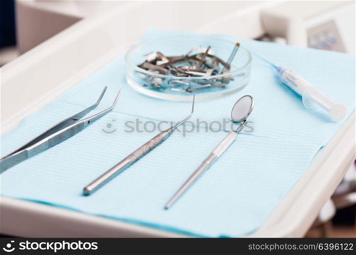 Dental instruments probe, tweezer, syringe and dental mirror for test the oral cavity. Tooth dental instruments