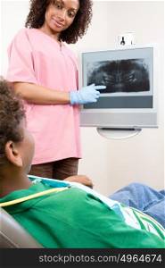 Dental nurse showing patient x ray