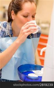 Dental patient woman rinse mouth after teeth check-up