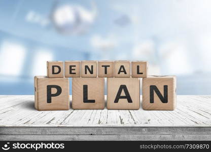 Dental plan sign with a blue room in the background with dentist equipment