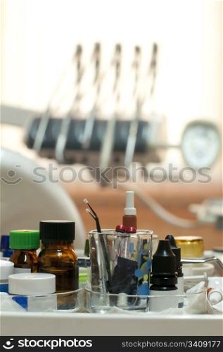 Dental supplies and equipment blurred on background. Vertical image