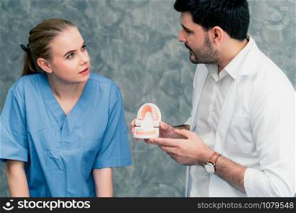 Dentist and nurse assistant working in dental office at the hospital. Dentistry concept.