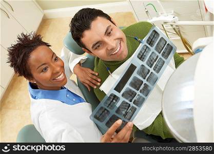 Dentist and Patient Examining X-ray