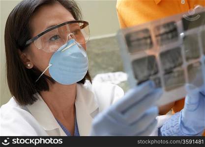 Dentist and Patient Examining X-rays