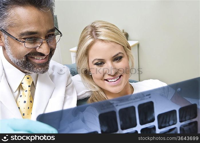 Dentist and patient looking at x-ray