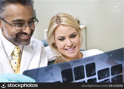Dentist and patient looking at x-ray