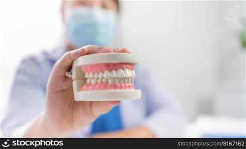 Dentist at dental clinic White healthy tooth with Dental model in oral surgeons discussing jaw x-ray on tablet medicine healthcare oral surgery concept