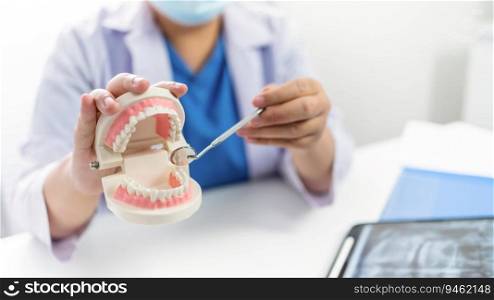 Dentist at dental clinic White healthy tooth with Dental model in oral surgeons discussing jaw x-ray on tablet medicine healthcare oral surgery concept