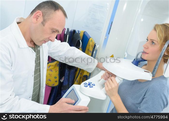 dentist checking results on a patient